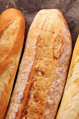 Top view of baguettes on wooden background
