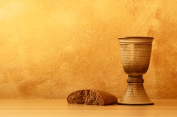 Chalice with wine and bread. Background with copy space.