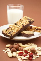 Granola bar, almonds, nuts, cranberries, oat flakes and milk