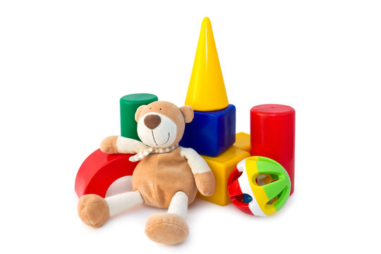 Box of bricks with a teddy bear and rattle