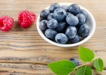 Blueberries and raspberry on wooden table