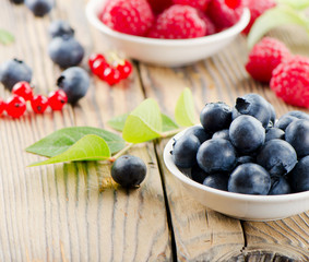 Blueberries and raspberry on wooden table