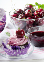 Cupcake with cherry on a wooden table. Selective focus