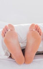 Feet sticking out from the quilt