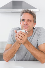 Man having coffee in kitchen in the morning