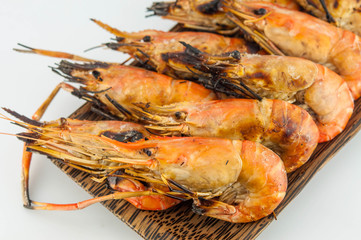 grilled prawns on wood white isolate