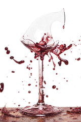 Broken wine glass with splashing wine 