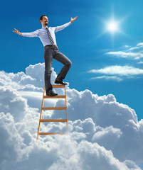 businessman with open arms standing at the top of ladder