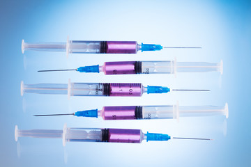 Injections in syringes with pink fluid