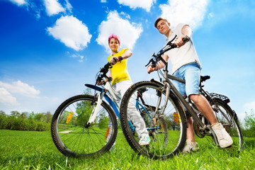 Happy young couple with bikes