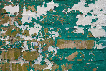 Green and White Paint Peeling off Yellow Brick Wall