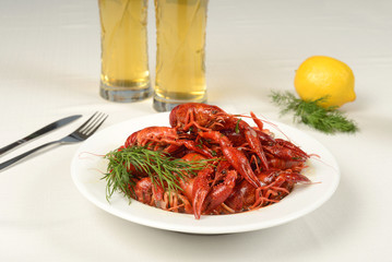river lobster on white tablecloth with beer, dill and lemon