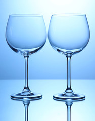 Empty wine glasses arranged on blue background