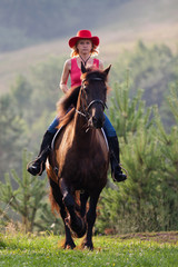 Woman in red hat riding