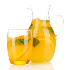 Orange lemonade in pitcher and glass isolated on white