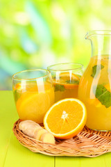 Orange lemonade in pitcher and glasses