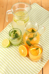 Orange and lemon lemonade in pitchers and glasses