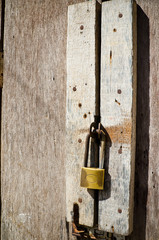 Old rusty hardwood door with key lock