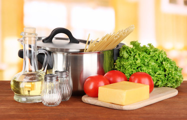 Ingredients for cooking pasta on table in kitchen