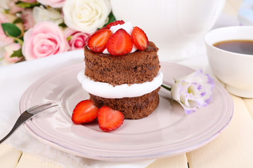 Chocolate cake with strawberry on table close-up