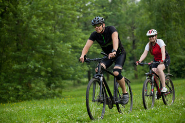 Fototapeta na wymiar Man and woman riding bicycles