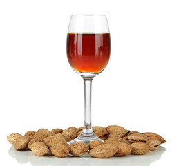 Glass of amaretto liquor and roasted almonds, isolated on white