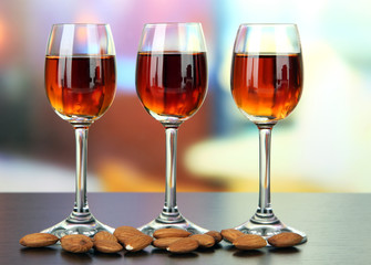 Glasses of amaretto liquor and roasted almonds,