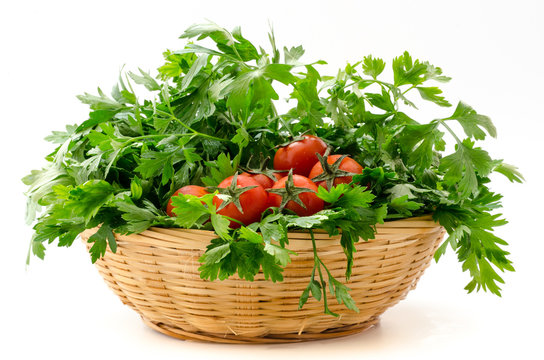 a basket of parsley and cherry tomatoes