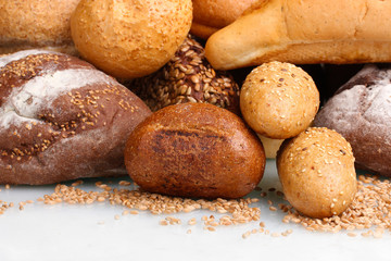 delicious breads and wheat isolated on white
