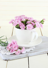 Many small pink cloves in cup