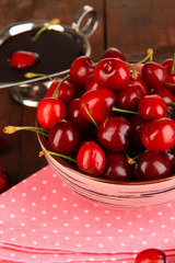 Ripe red cherry berries in bowl and chocolate sauce