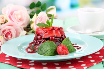 Tasty jelly dessert with fresh berries, on bright background