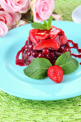 Tasty jelly dessert with fresh berries, on bright background