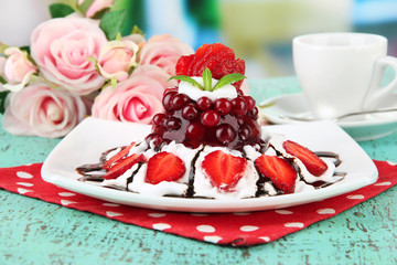 Tasty jelly dessert with fresh berries, on bright background