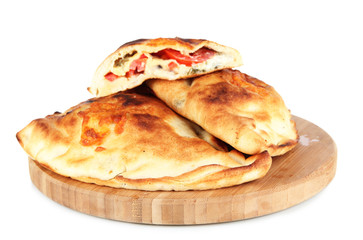 Pizza calzones on wooden board isolated on white