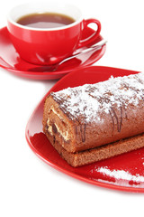 Sweet roll with cup of tea isolated on white