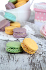 Macaroons in bowl on wooden table close-up