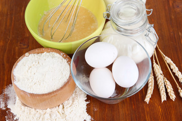 Ingredients for dough on wooden table close-up
