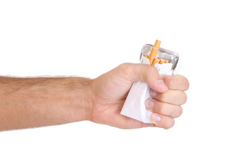 Fist with crushed pack of cigarettes, isolated on white