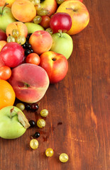 Naklejka na ściany i meble Assortment of juicy fruits, on wooden background
