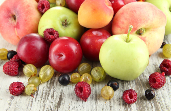 Assortment of juicy fruits, on wooden background