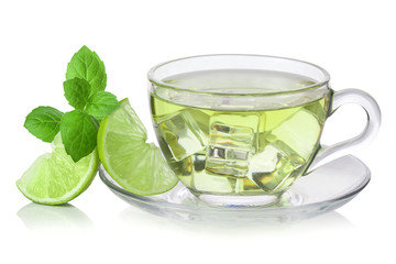 Cold green tea with ice cubes, lime sliced and mint leaves