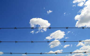 Blue Sky and Clouds with Barbwire