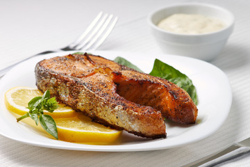 Grilled Salmon Steak with Lemon and Basil on Plate