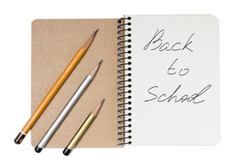 Notebook with pencils isolated on white