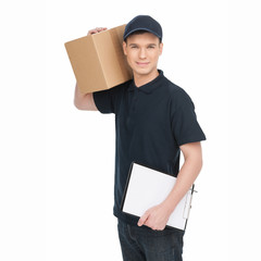 Young deliveryman at work.  Cheerful young deliveryman holding c