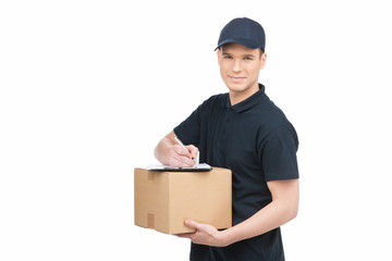 Confident deliveryman at work. Cheerful young deliveryman holdin