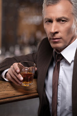 Relaxing after a hard working day. Confident mature businessman