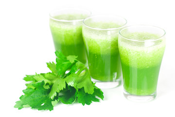 celery and three glasses with celery juice isolated on white