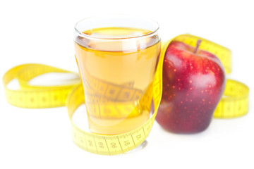 measuring tape,apples and glass of apple juice isolated on white